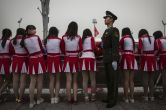 Give me an M! Give me an O! Tech firms in China hire female cheerleaders to 'motivate' men 