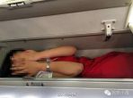 #Bizarre: Chinese airline stewardesses stuffed into overhead bin as part of a ritual 