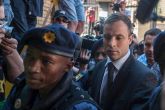 Blade-runner Oscar Pistorius walks into police station for community service 