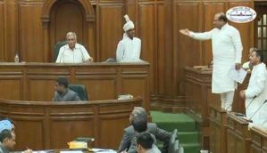 Taking a stand: BJP lawmaker clambers up on a bench in Delhi Assembly 