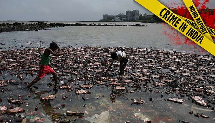 People collecting biscuits packets from the shore, on 9 August 2010, that had accumulated after cargo ship MSC Chitra sunk in the Arabian Sea