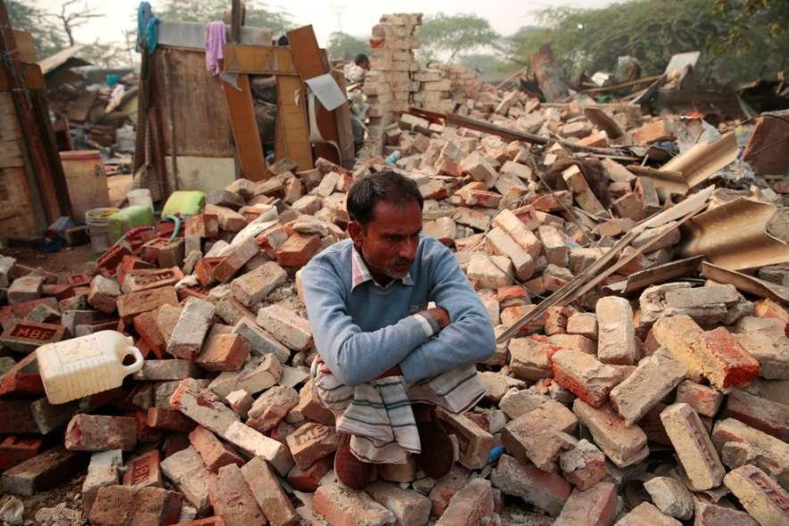A man sits on rubble that was once his house. The MCD demolished a slum in Mehrauli, New Delhi that left almost 1500 people homeless.