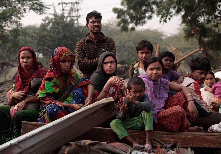 Slum dwellers watch as their homes get demolished. The MCD demolished a slum in Mehrauli, New Delhi that left almost 1500 people homeless.