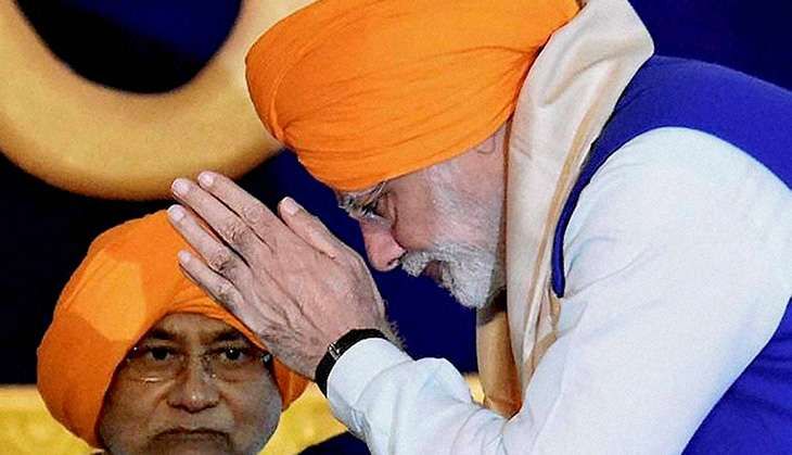 Prime Minister Narendra Modi offers prayers as Bihar Chief Minister Nitish Kumar looks on during 350th birth anniversary celebrations of Guru Gobind Singh at Gandhi Maidan in Patna on Thursday