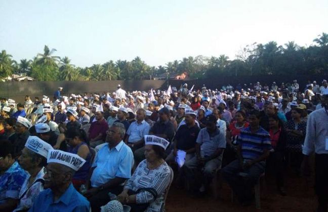 Attendees at the rally wear Aam Aadmi Party caps