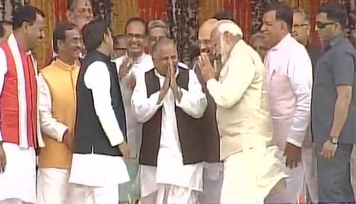 Mulayam Singh Yadav & Akhilesh Yadav interact with PM Narendra Modi after swearing-in ceremony