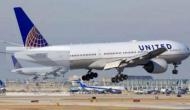 United forces mom to hold boy after giving away his seat