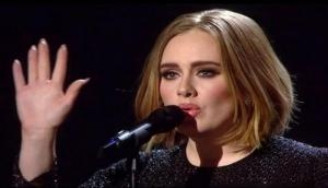 Emotional Adele visits London fire site, comforts victims