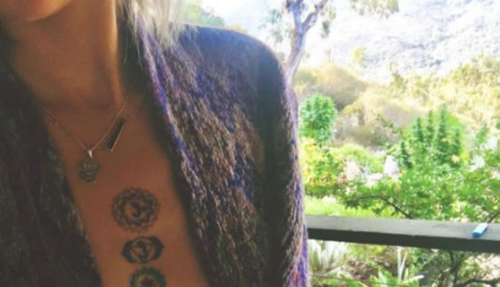Michael Jackson's daughter Paris goes topless to flaunt her new 'Om' tattoo