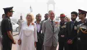 In Photos: Prince Charles and Camilla greeted with the capital's smog