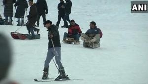 Tourists enjoy snowfall at Gulmarg, steady business for sledge owners