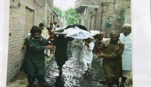  Picture of funeral procession through sewerage water calls for an investigation