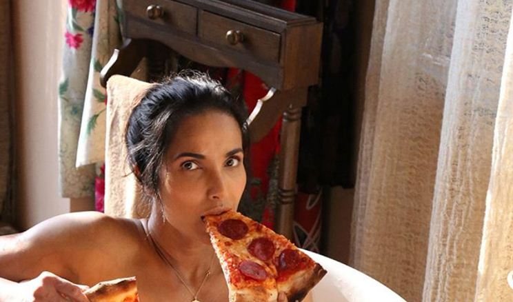 Model Padma Lakshmi enjoys pizza slices in a bathtub for a seductive naked photoshoot 