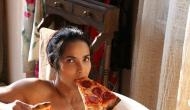 Model Padma Lakshmi enjoys pizza slices in a bathtub for a seductive naked photoshoot 