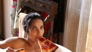 Model Padma Lakshmi enjoys pizza slices in a bathtub for a seductive naked photoshoot 