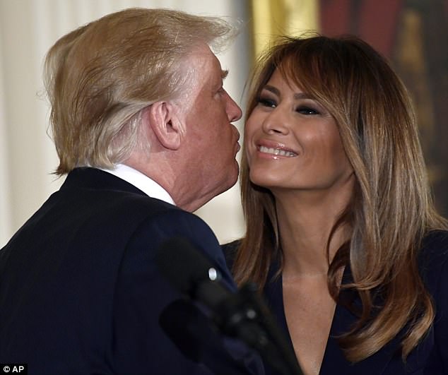 Melania and Trump's rare PDA moment as they kiss and hug in public, but is all well
