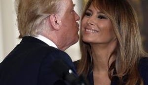 Melania and Trump's rare PDA moment as they kiss and hug in public, but is all well