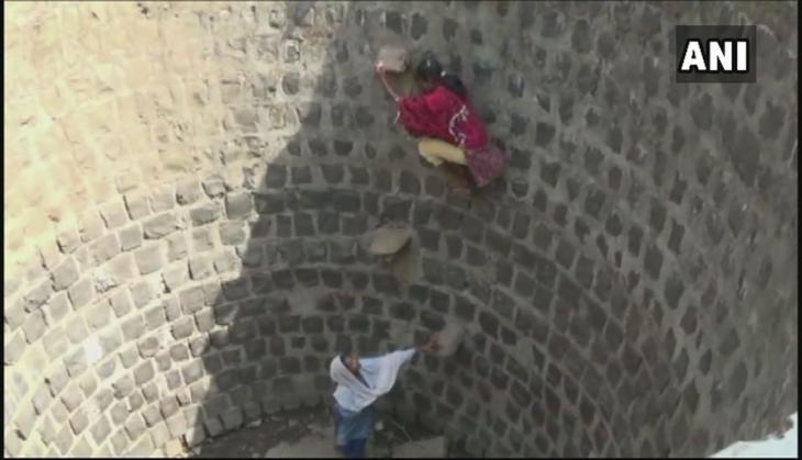 Girls climb down in Well