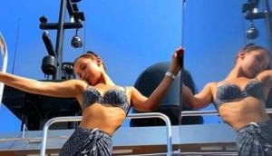  Bella Hadid shares picture in Dior bikini and Nikes as she boards a boat for appearance at Monaco Grand Prix