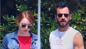 Justin Theroux shows off his abs while Emma Stone wears sexy red swimsuit in France