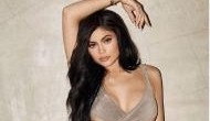 Kylie Jenner shows off her bra and abs in open French coat on Instagram