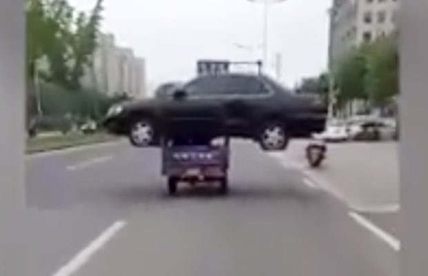 Viral Video: A rickshaw carrying black sedan car on its top and travelling on the roads of China