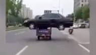 Viral Video: A rickshaw carrying black sedan car on its top and travelling on the roads of China