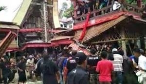 Watch Video: Mother's coffin falls on son in Indonesia funeral