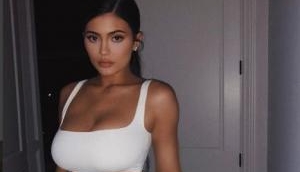 Kylie Jenner wears bra out to dinner, with Alexander Wang Leggings and Yeezy Mules