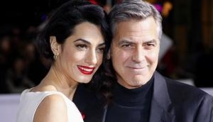 George and Amal Clooney donate $100,000 to help migrant children 