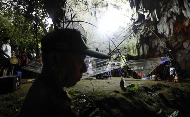 Crying parents gather outside cave where 12 young football players are trapped