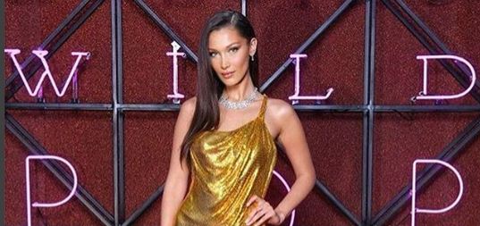 Bella Hadid stuns in a sexy gold Versace dress at Bulgari dinner in Rome