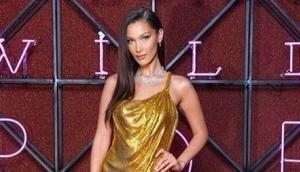Bella Hadid stuns in a sexy gold Versace dress at Bulgari dinner in Rome