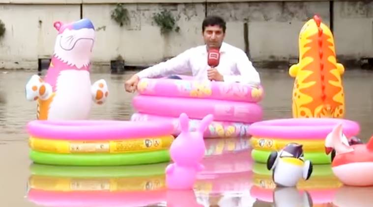 Watch Video: Pakistani reporter sits floating tube on flooded road to cover heavy rainfall 