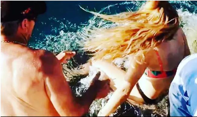 Shocking Video: Woman feeding shark gets dragged into water