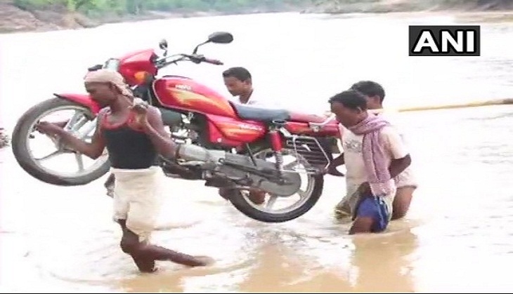 Jharkhand: In absence of bridge, villagers cross river on foot