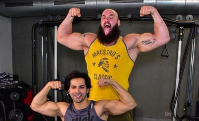 Bollywood actor Varun Dhawan flex muscle with WWE superstar Braun Strowman 