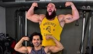 Bollywood actor Varun Dhawan flex muscle with WWE superstar Braun Strowman 