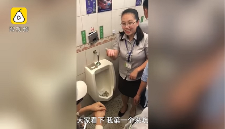Woman eats from urinal