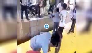 UP: Shocking! School bus stuck in deep water under railway bridge, children rescued one by one; video goes viral