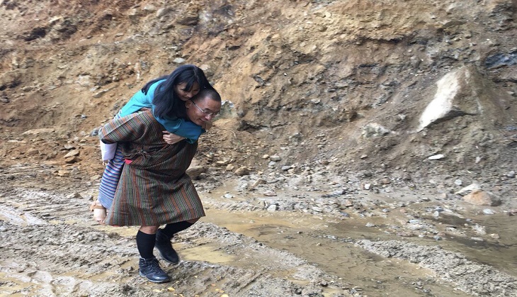 Former Bhutan PM Tshering Tobgay carried his wife on back to prevent dirtying her feet; this romantic picture goes viral