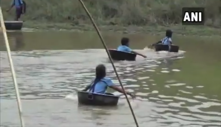 children crossing river on a pot