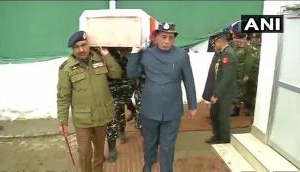 Pulwama Attack: Rajnath Singh lends shoulder to mortal remains of a CRPF soldier in wreath laying ceremony