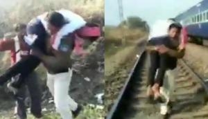 Video: Salute! Cop runs on rail track carrying seriously injured man in Hoshangabad; wins heart on internet