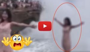 Watch this hair-raising video of a woman who swept away by gigantic wave while posing on a cliff