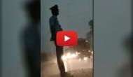 Salute! See how a traffic constable did his duty with dedication during thunder shower; Twitterati call him ‘asli chowkidar’