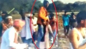 Watch: Shame! Woman forced to carry husband on shoulder as punishment for having affair with man from different caste