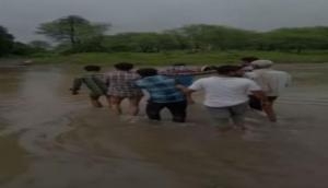 Madhya Pradesh: Locals carry pregnant woman on cot amid heavy rainfall 