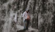 Husband mimics different maternity poses in front of waterfall, gives hilarious surprise to pregnant wife