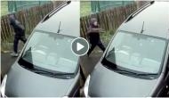Thief tries to break car glass via brick, hit himself instead; video will teach you how karma pays back!